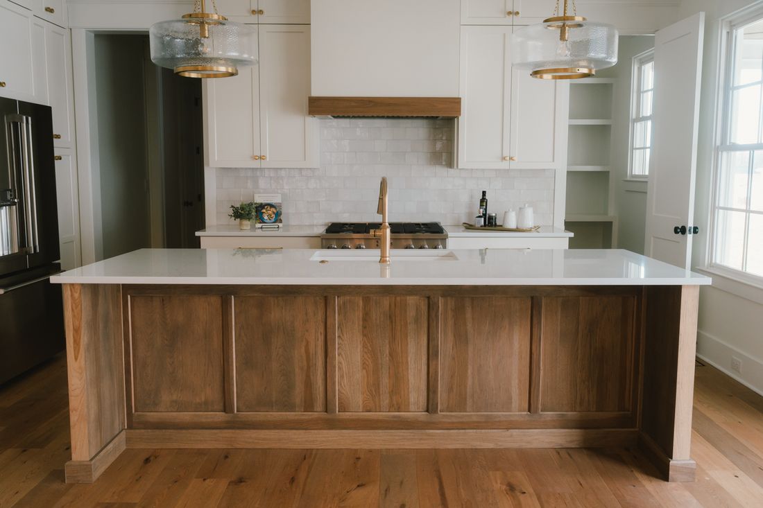 Kitchen with a pale blue island and waterfall stone edge