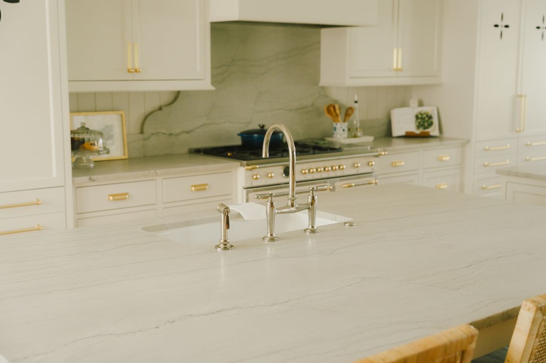Close-up of veined quartz countertop and apron sink